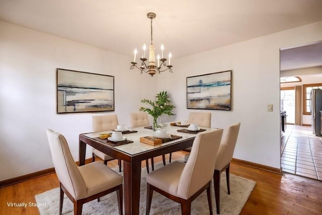 dining room featuring hardwood / wood-style floors and a chandelier