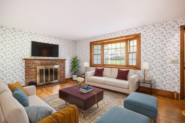 living room featuring a fireplace and light wood-type flooring