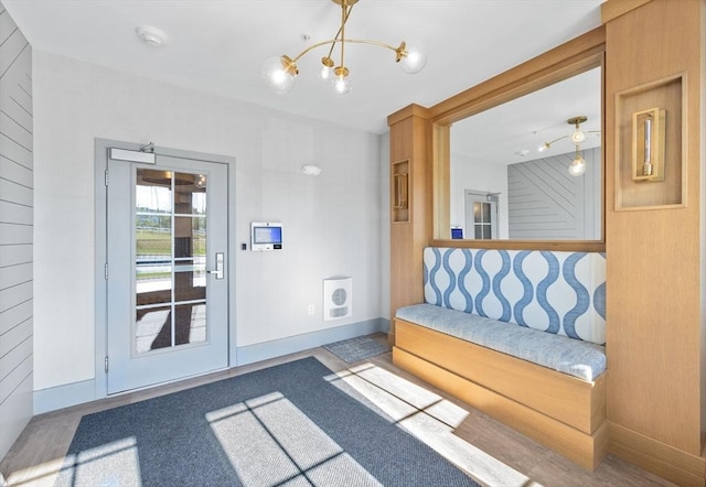 doorway featuring visible vents, baseboards, and an inviting chandelier