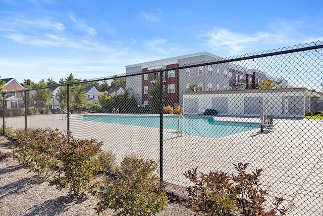 view of swimming pool featuring fence