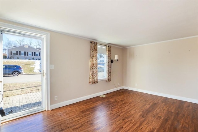 unfurnished room featuring ornamental molding and hardwood / wood-style floors