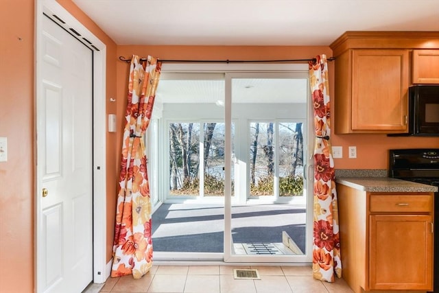 entryway with light tile patterned floors