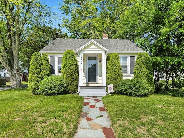 307 Boutelle St, Fitchburg, MA 01420 - bungalow-style home featuring a front lawn, a chimney, and roof with shingles