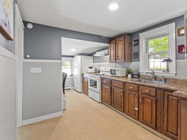 307 Boutelle St, Fitchburg, MA 01420 - kitchen with white appliances, range hood, baseboard heating, brown cabinetry, and recessed lighting