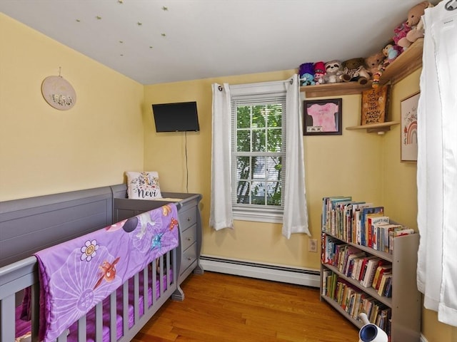 307 Boutelle St, Fitchburg, MA 01420 - bedroom featuring baseboard heating and wood finished floors