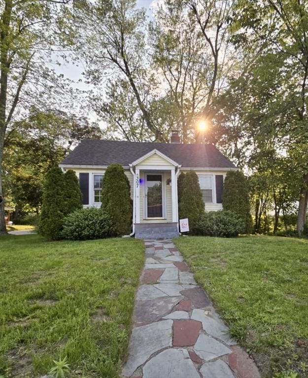 307 Boutelle St, Fitchburg, MA 01420 - view of front of house with a chimney and a front yard