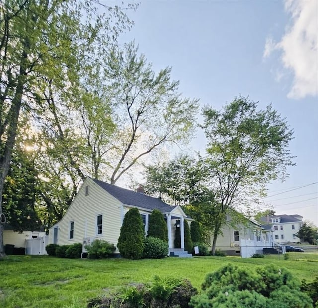 307 Boutelle St, Fitchburg, MA 01420 - view of front of property with a chimney and a front lawn