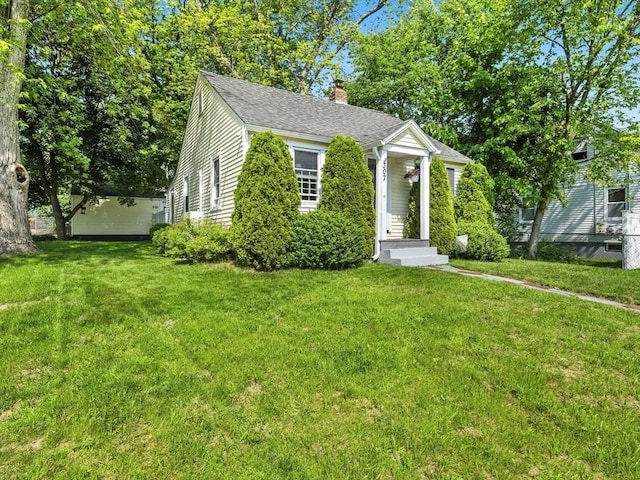 307 Boutelle St, Fitchburg, MA 01420 - view of front of house with a chimney, a front lawn, and roof with shingles