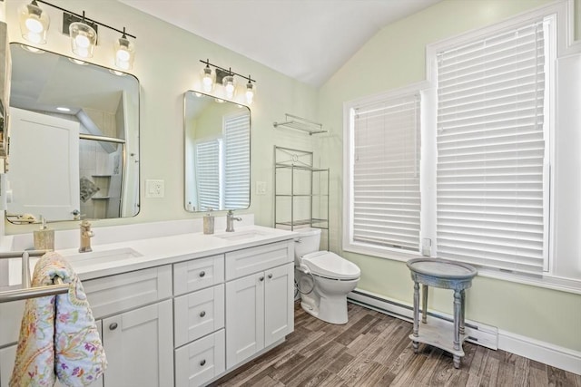 full bath featuring lofted ceiling, toilet, a sink, a stall shower, and wood finished floors