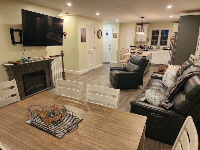 living room featuring light hardwood / wood-style flooring and a fireplace