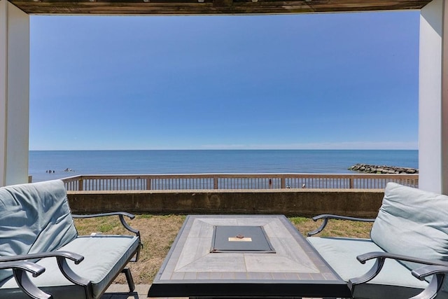 view of patio featuring outdoor dining area and a water view