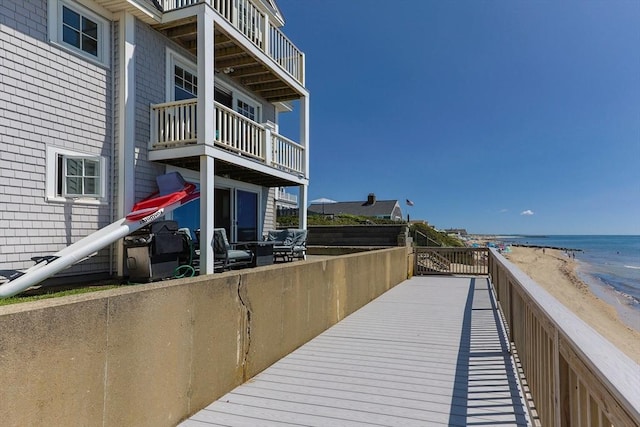exterior space with a water view and a beach view