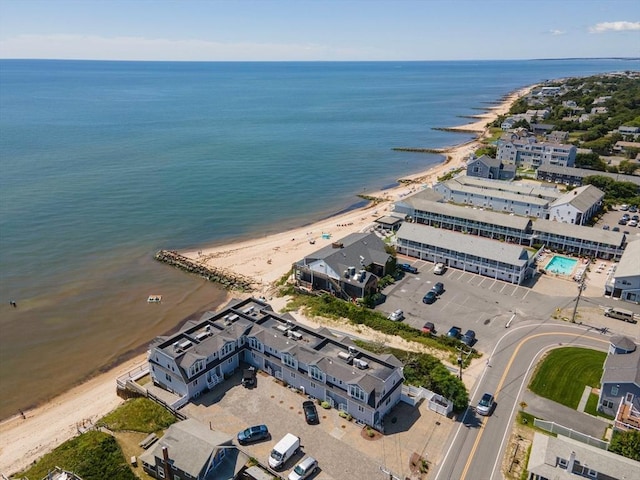 bird's eye view with a water view and a beach view