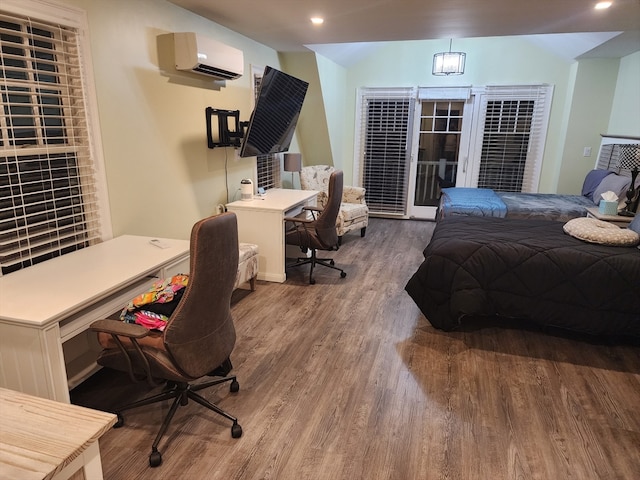 bedroom featuring access to outside, a wall unit AC, and hardwood / wood-style floors