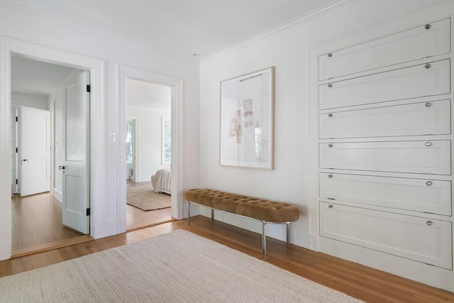 hall with hardwood / wood-style floors and ornamental molding