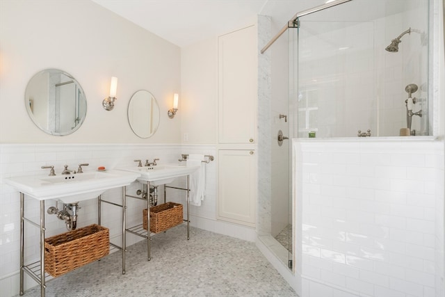 bathroom with a tile shower and tile walls