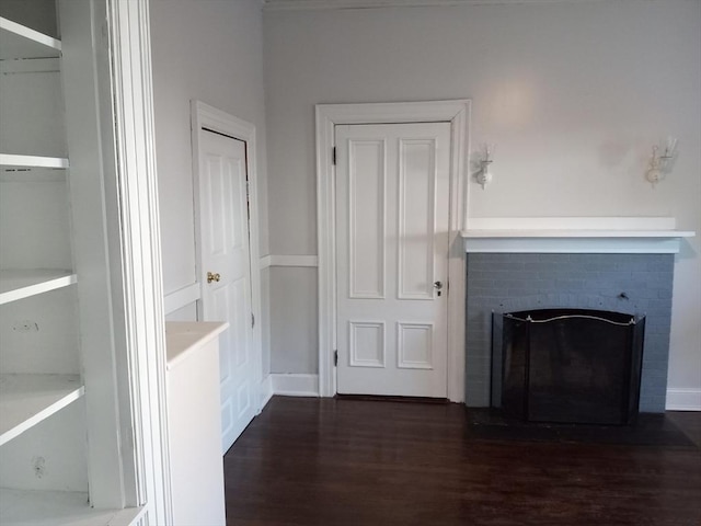 unfurnished living room featuring a fireplace and wood finished floors