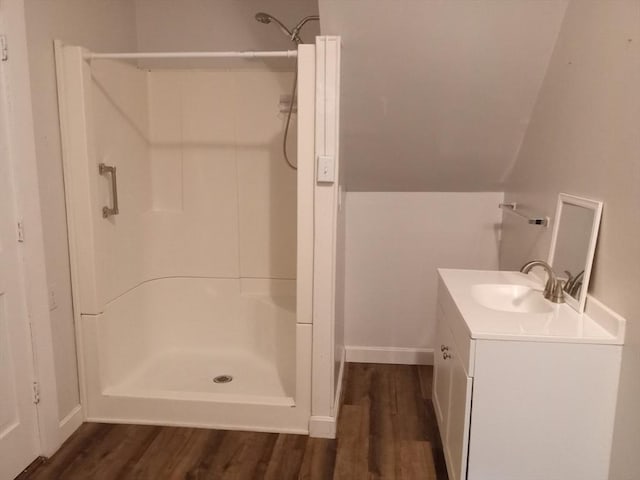 full bathroom featuring vanity, wood finished floors, and a stall shower