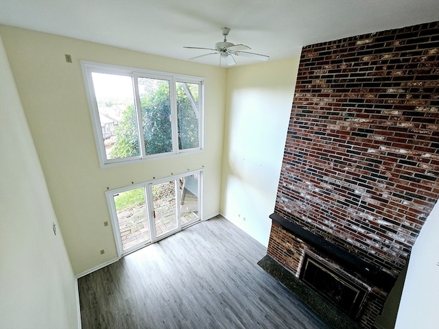 unfurnished living room featuring hardwood / wood-style floors and ceiling fan