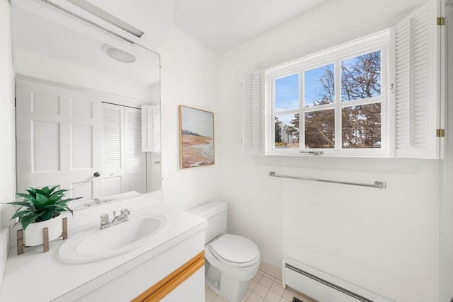 bathroom with baseboard heating, vanity, toilet, and tile patterned floors