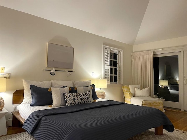 bedroom featuring lofted ceiling and wood finished floors