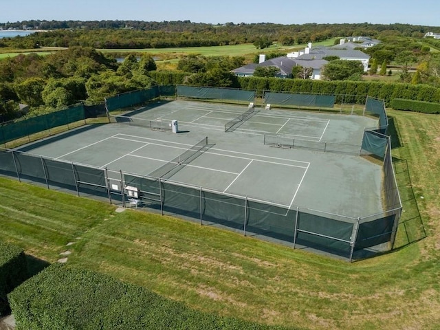 view of sport court with fence and a yard