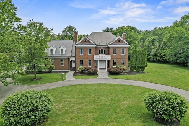 2 Azalea Way, Boxford, MA 01921 - colonial house featuring a chimney, curved driveway, and a front yard