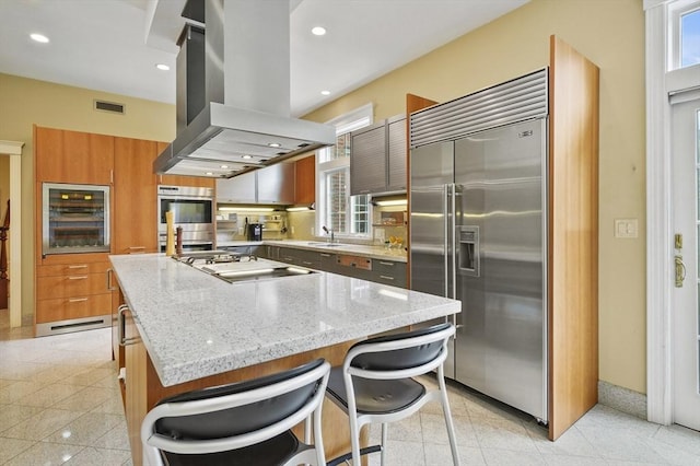 2 Azalea Way, Boxford, MA 01921 - kitchen with appliances with stainless steel finishes, island range hood, beverage cooler, a kitchen island, and plenty of natural light