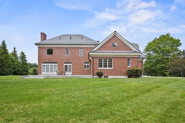 2 Azalea Way, Boxford, MA 01921 - rear view of property featuring brick siding, a chimney, a lawn, and a patio