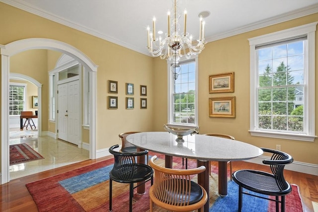 2 Azalea Way, Boxford, MA 01921 - dining area with arched walkways, a chandelier, healthy amount of natural light, ornamental molding, and wood finished floors