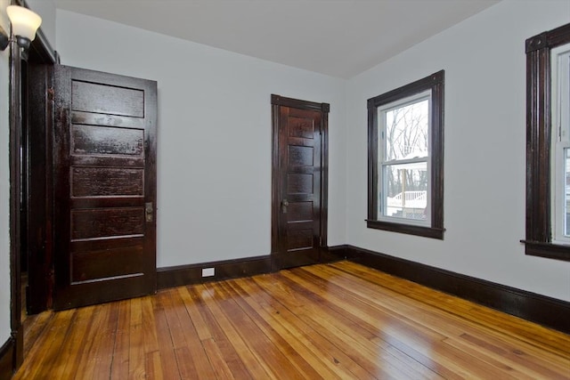 interior space with hardwood / wood-style floors and baseboards