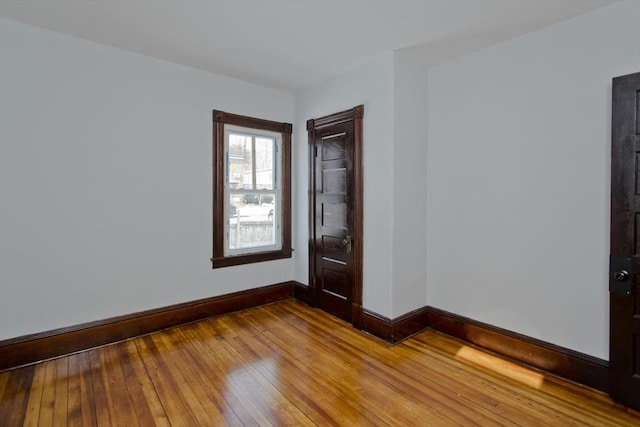 empty room featuring light wood-style floors and baseboards