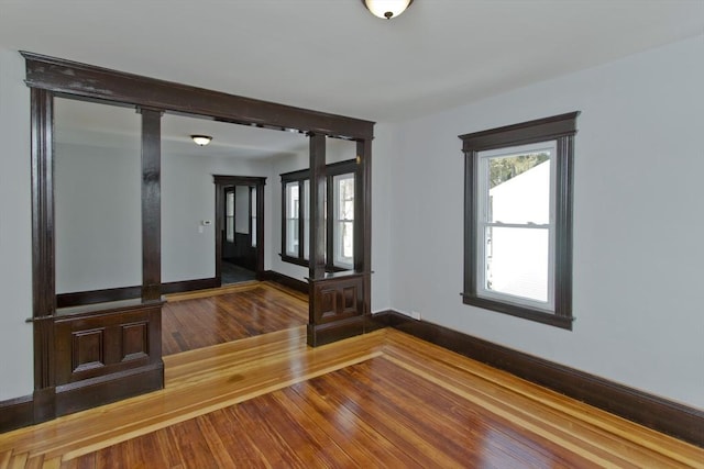 foyer entrance with hardwood / wood-style flooring and baseboards