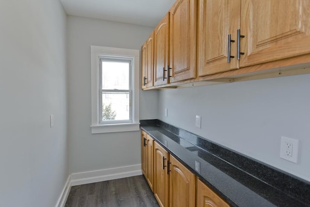 kitchen with dark wood-style flooring and baseboards