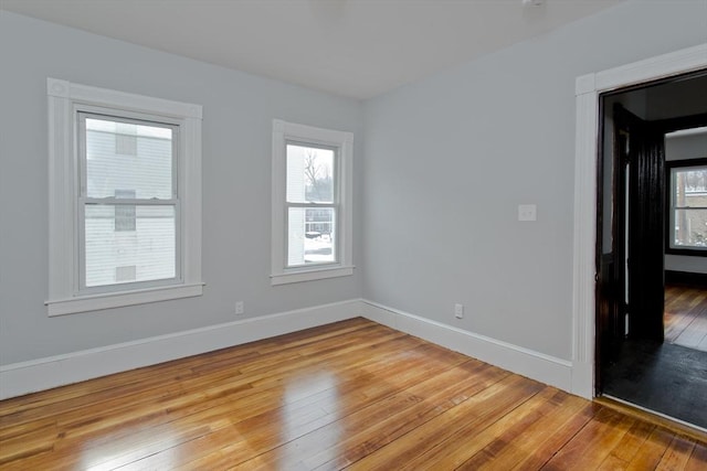 spare room with light wood finished floors and baseboards