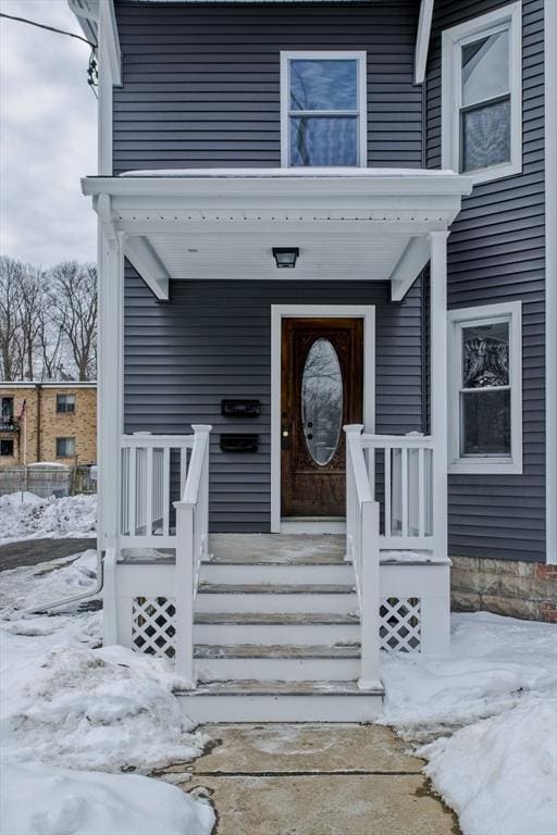 view of snow covered property entrance