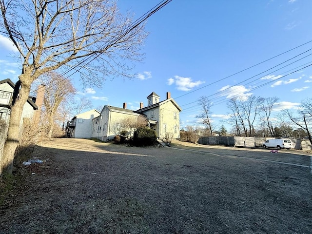 view of side of home featuring fence
