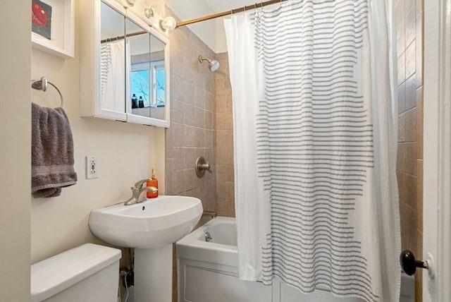 bathroom with toilet and shower / tub combo with curtain