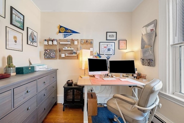 office featuring wood finished floors, baseboards, a wealth of natural light, and a baseboard radiator