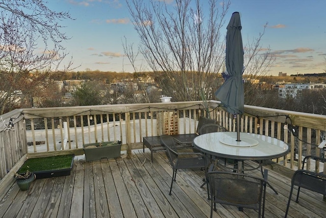 deck at dusk with outdoor dining area