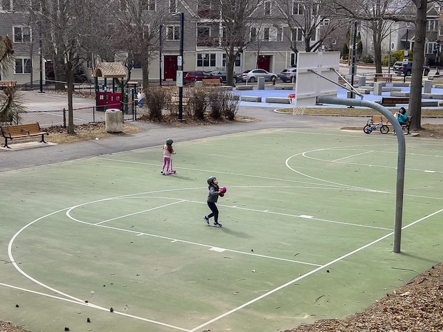 view of basketball court with community basketball court and fence