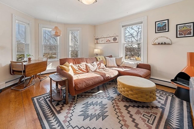 living area with wood-type flooring and a baseboard radiator