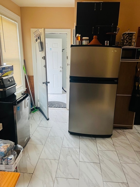 kitchen featuring a wealth of natural light and stainless steel refrigerator