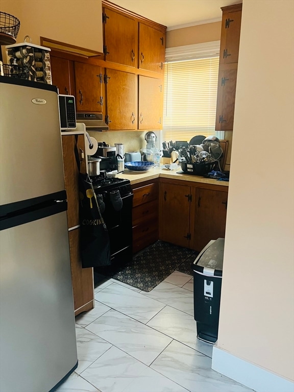 kitchen with black appliances and extractor fan