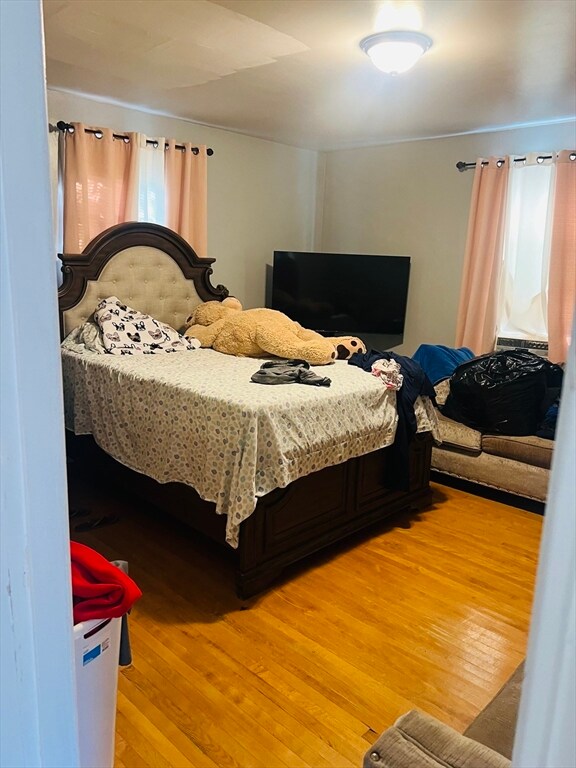 bedroom with wood-type flooring