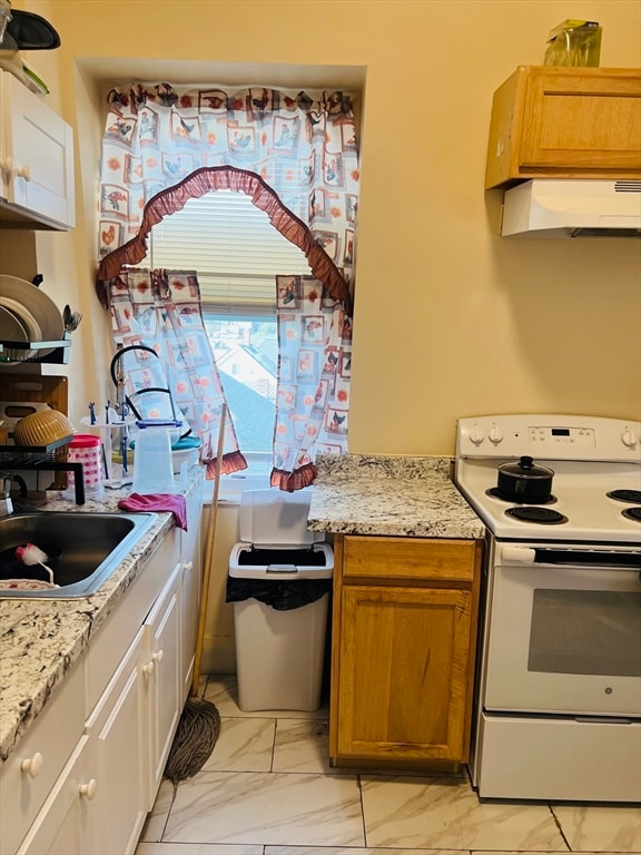 kitchen featuring white electric stove, sink, and light stone countertops