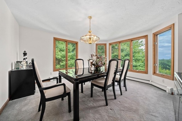 carpeted dining space featuring a baseboard heating unit, a notable chandelier, baseboards, and a textured ceiling