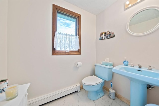 half bathroom featuring toilet, baseboards, marble finish floor, and a baseboard radiator