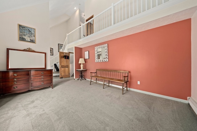 sitting room featuring light carpet and high vaulted ceiling