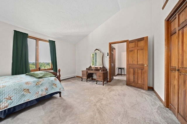 bedroom featuring a closet, a baseboard radiator, and light colored carpet